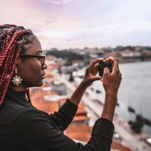 Afro tourist girl shooting cityscape