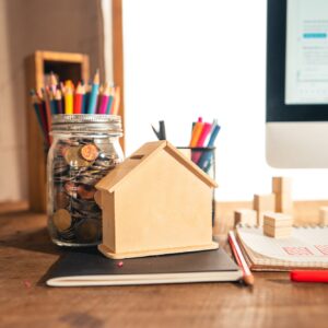Money in a glass jar On the desk at home