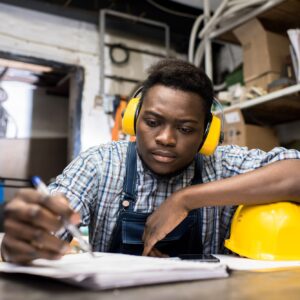 Thoughtful young engineer working in dark room