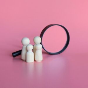Wooden dolls and magnifying glass